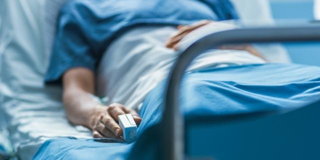 A patient lays in a hospital bed