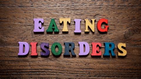 Block letters spelling the words eating disorders